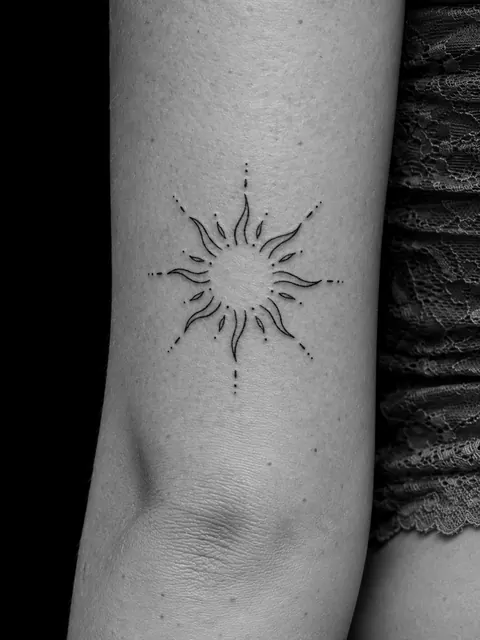 Sol de línea fina con rayos ondulados y líneas de puntos en la parte trasera de un brazo